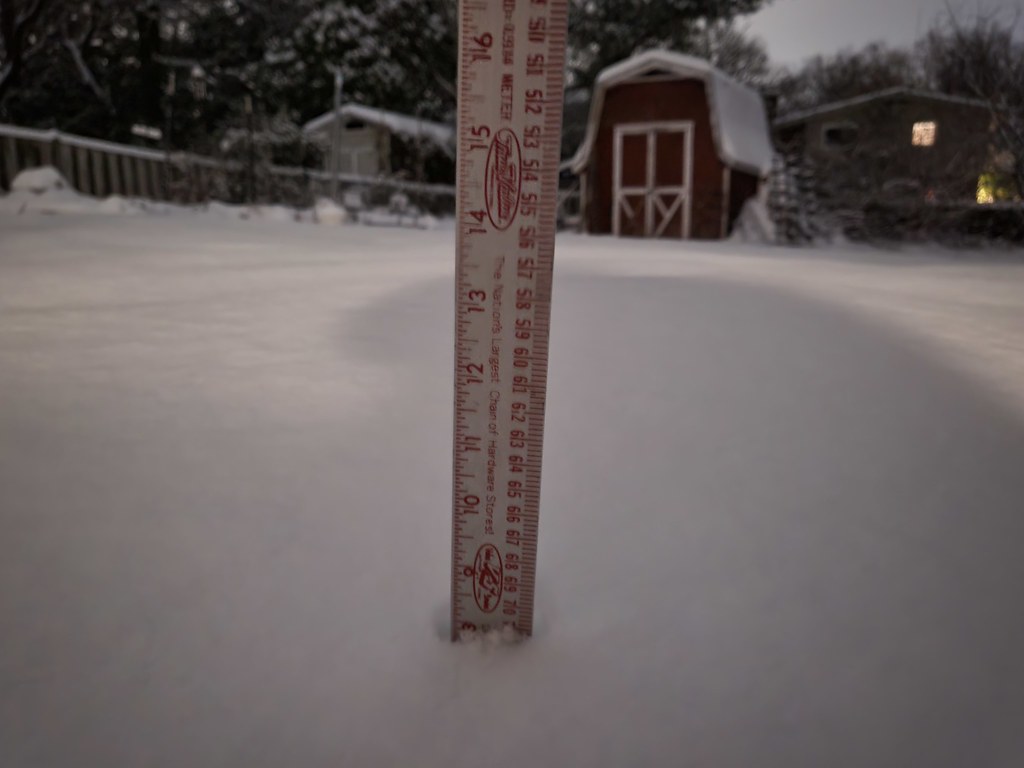 A yard stick measures 7.75 inches of snow in Alexandria, Va. on January 6, 2024